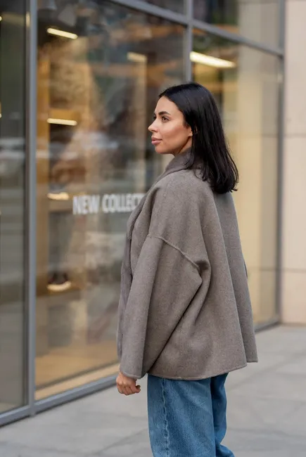 A laconic cashmere coat in grey-beige colour 